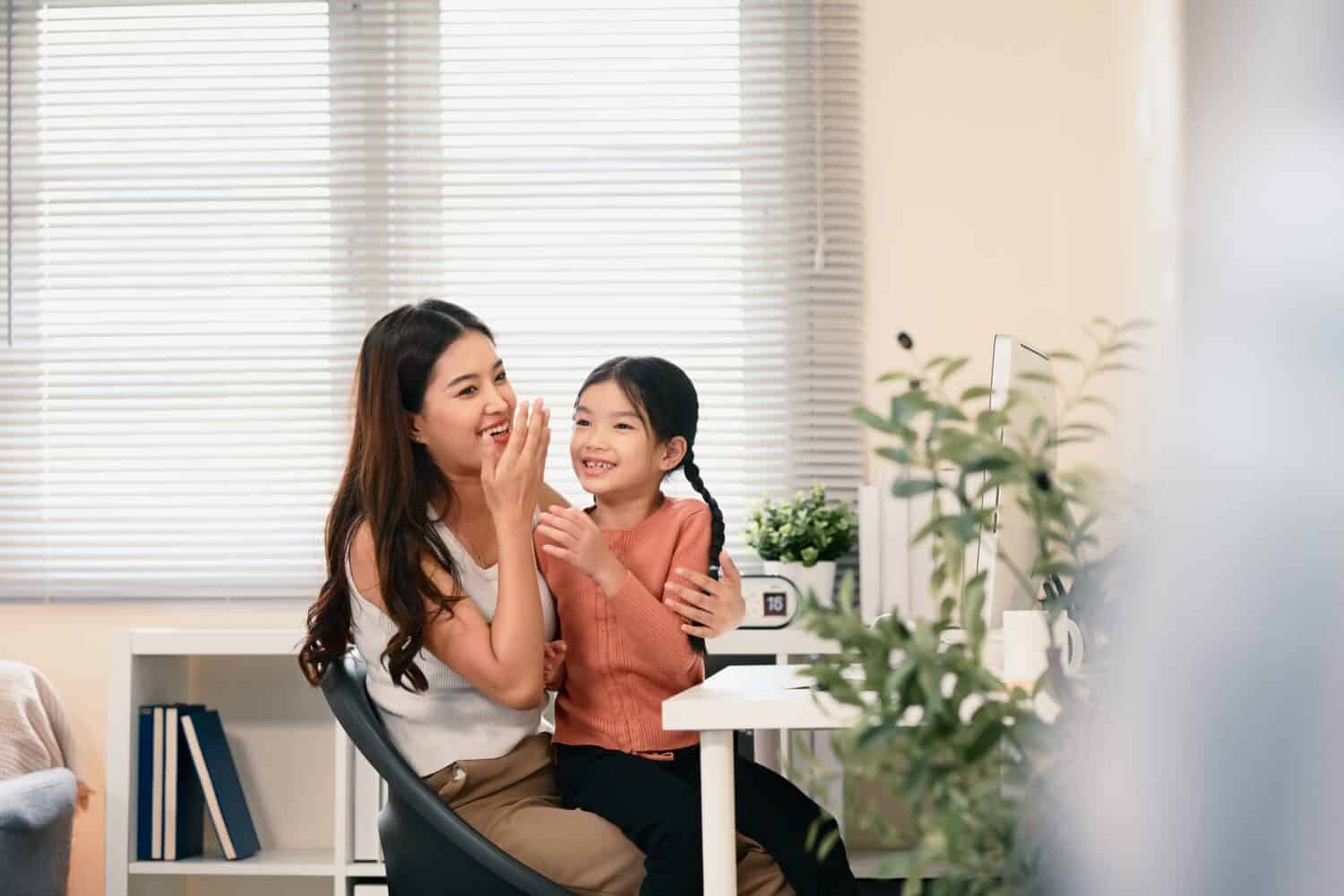 Mom and child practicing Chinese pronunciation together in a bright living room