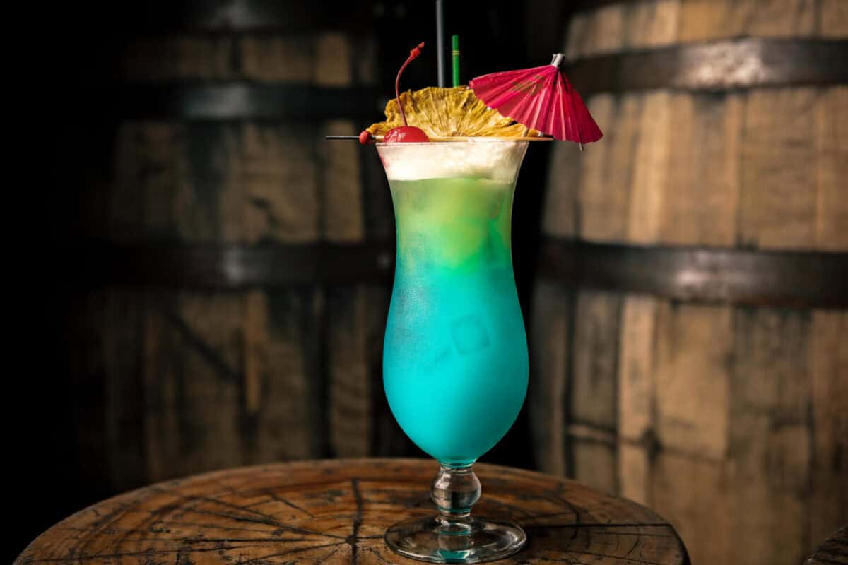 Refreshing cocktail made with blue curacao, served in a hurricane glass, with a cherry, pineapple slice and a small umbrella. It's Tiki time!