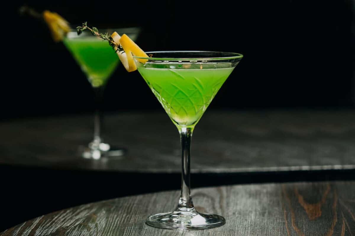 Green Alcohol Cocktail in martini classic glass