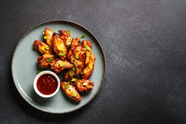Chicken wings in bbq sauce grilled .