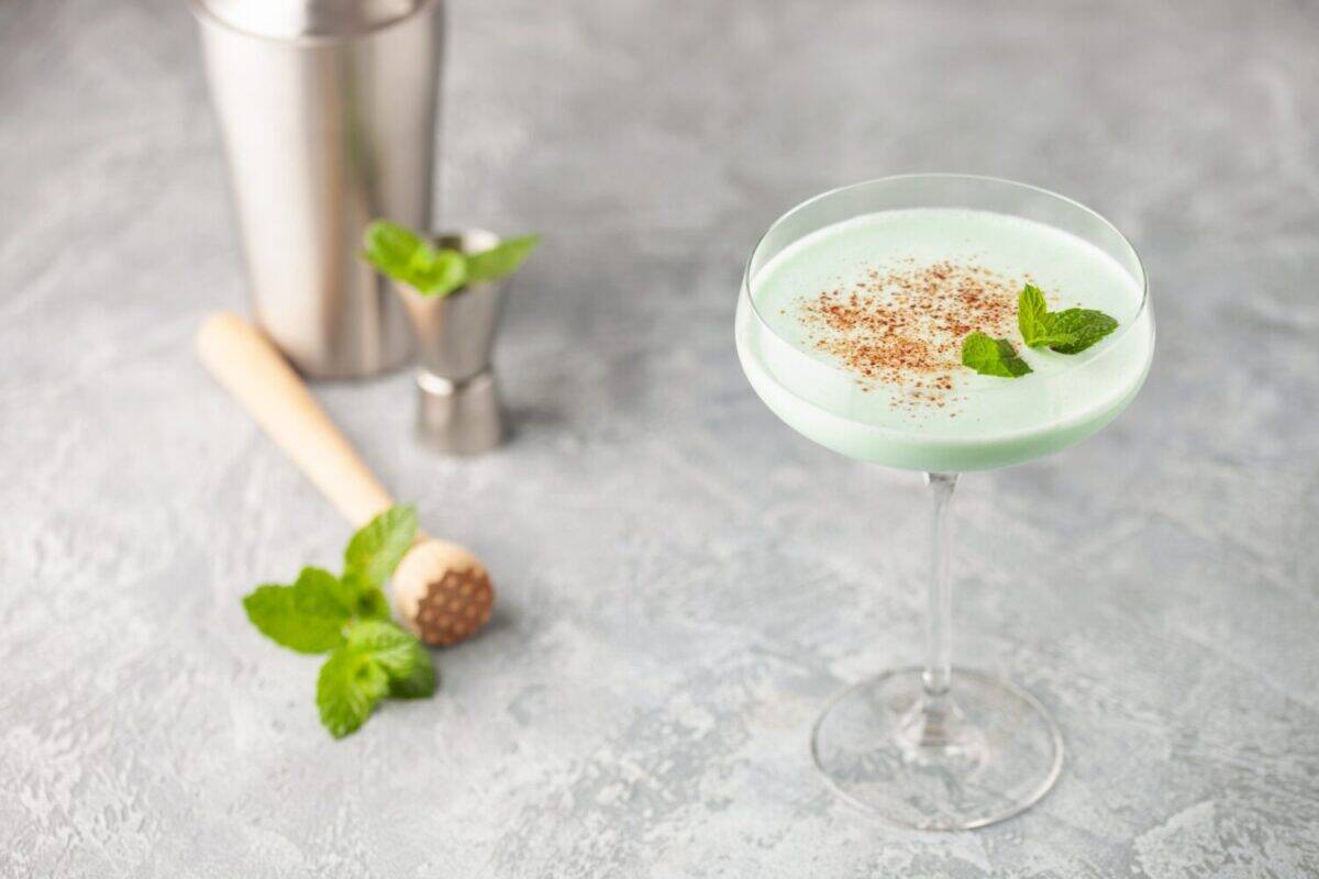 Grasshopper cocktail from New Orleans, with green mint liqueur, chocolate liqueur and cream in cocktail glass.