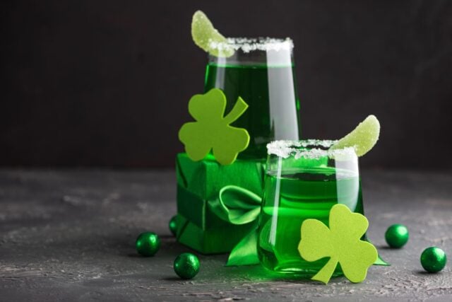 Green Cocktails with Shamrocks and Gifts. Festive St. Patricks Day Celebration Still Life