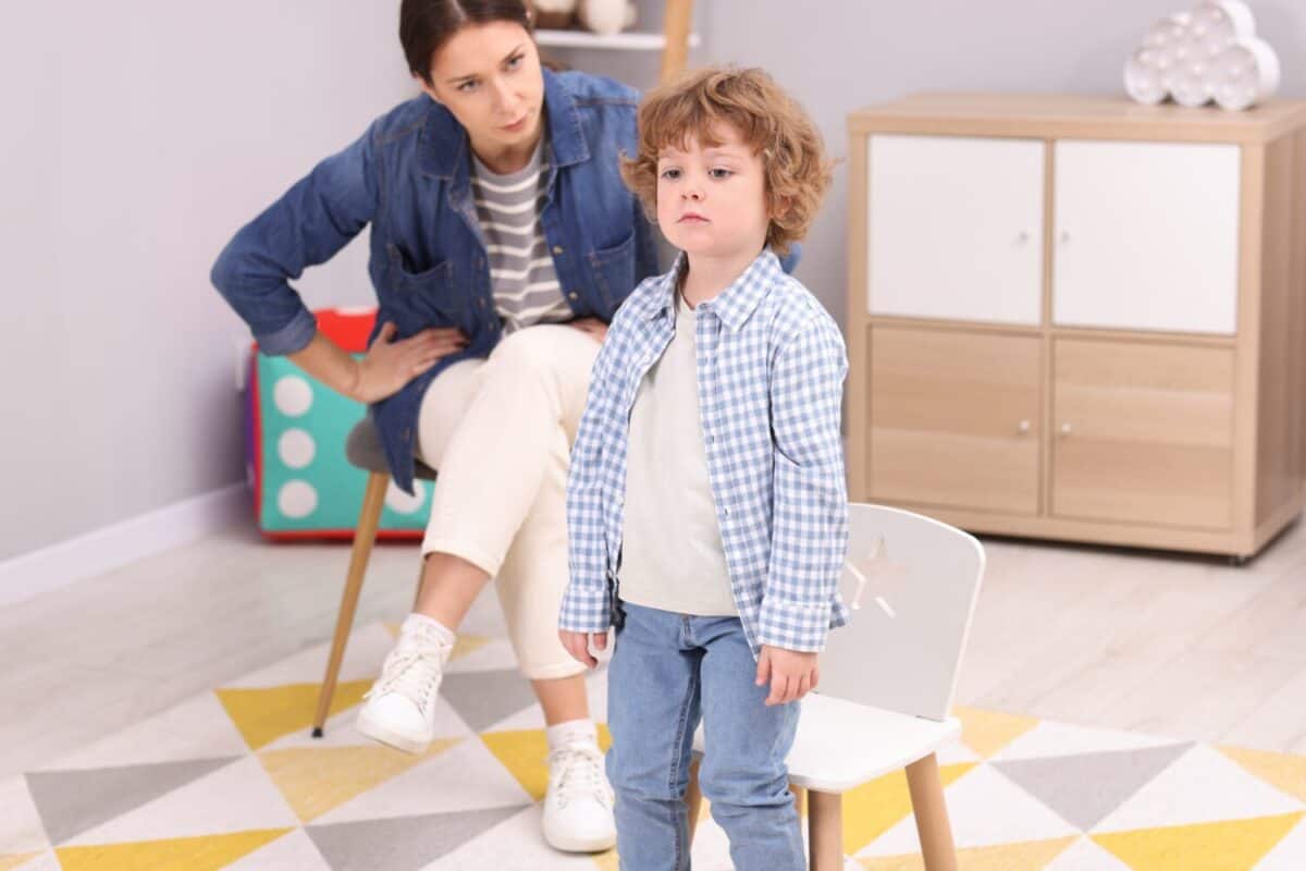 Resentful little boy and his mother arguing at home
