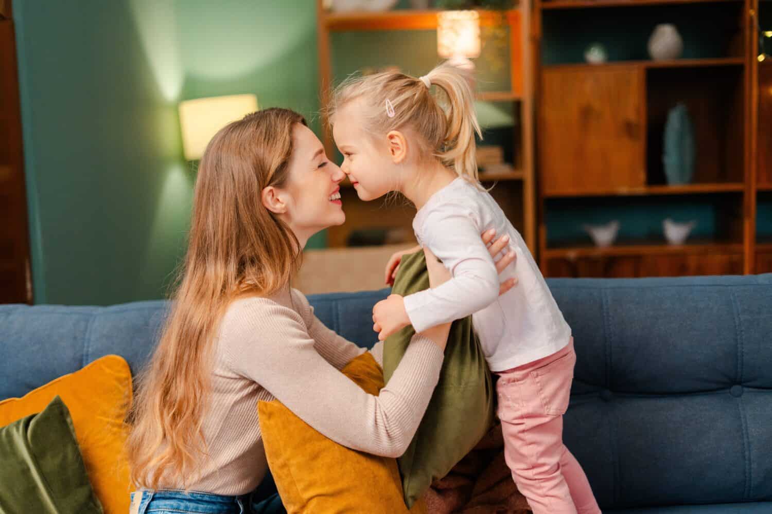 Mother and daughter bonding with a warm smile, showing love and affection at home