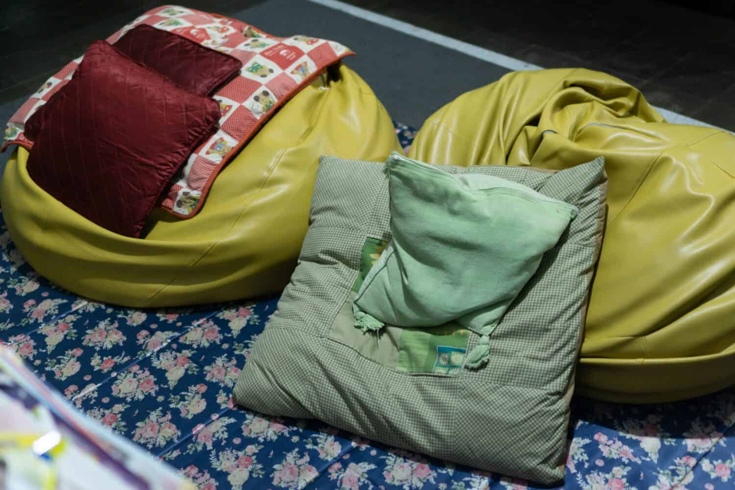 Wrinkle messy pillow and bean bag scattered in living room after relaxing sit watching tv and sleep.
