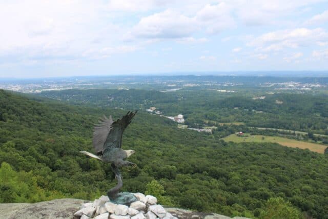Eagle sculpture overlooking a green landscape near Rock City Gardens atop Lookout Mountain in Georgia near Chattanooga, Tennessee