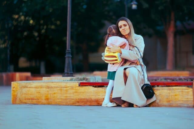 Sad Mother Hugging Girl Going to Preschool Mum suffering from separation anxiety from her little kid