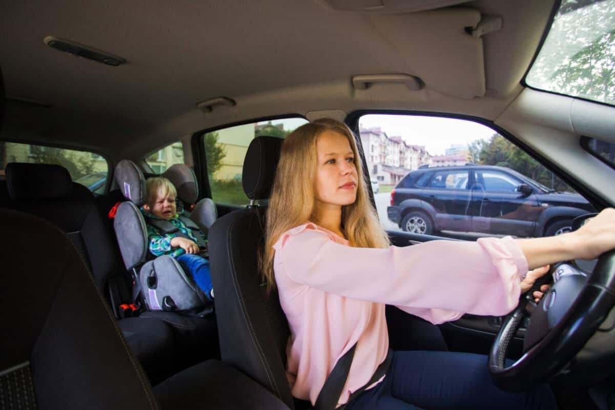 Female nanny drive the car and deliver toddler boy