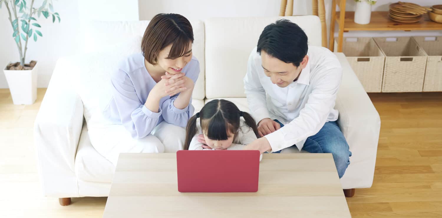 Asian girl and parents watching a laptop pc. Online education. e-learning.