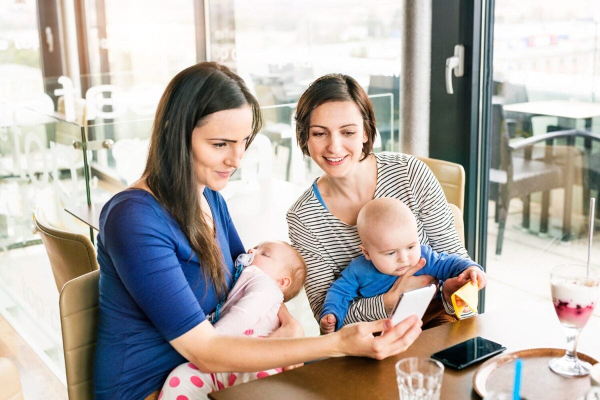 New mom friends going to cafe with babies. Spending free time during maternity leave together in city.