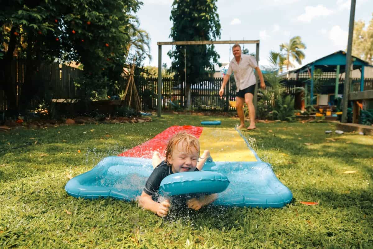 Summer backyard slip and slide family fun