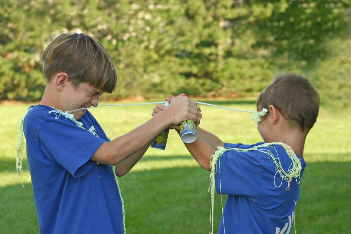 Boys Shooting String at Each Other