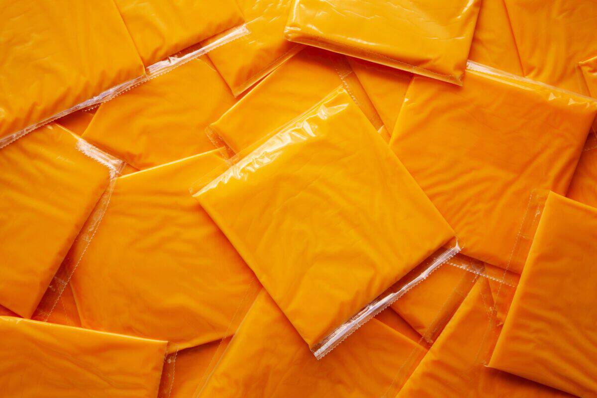 American Cheese Slices in Wrappers, top view. Flat lay, overhead.