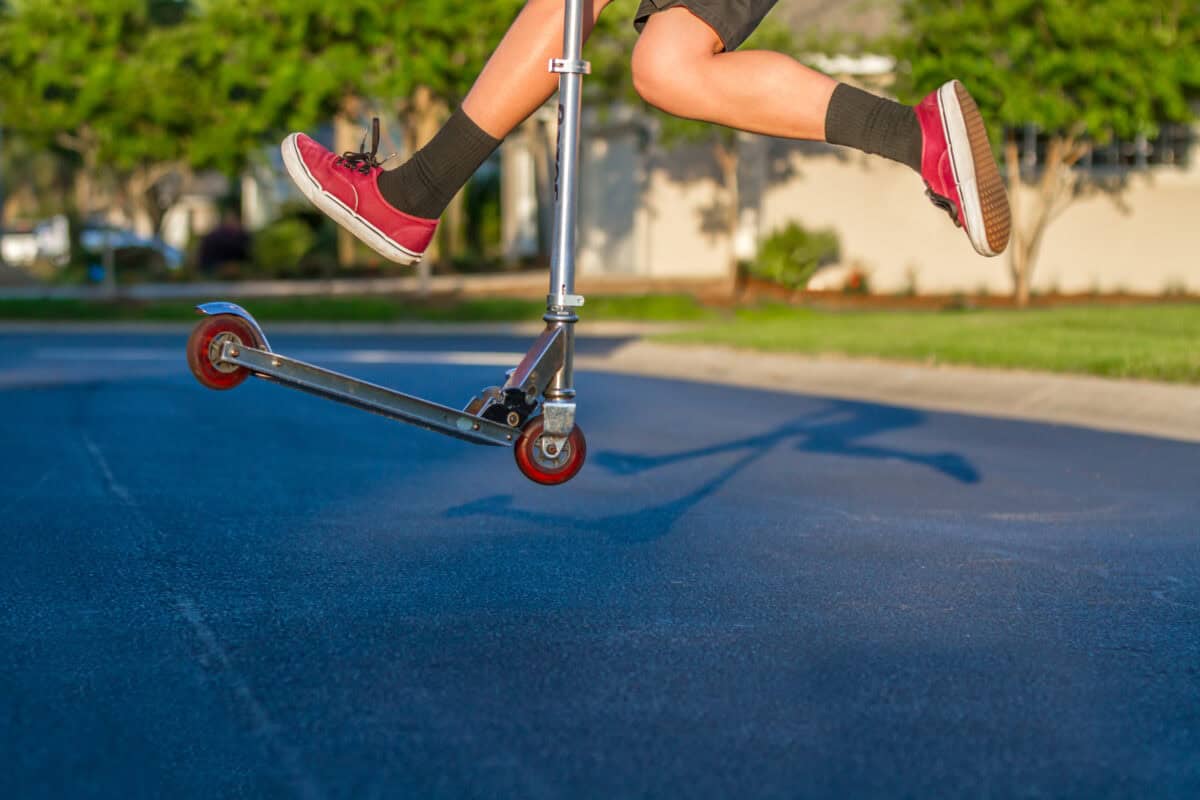 Boy Jumping High on Scooter