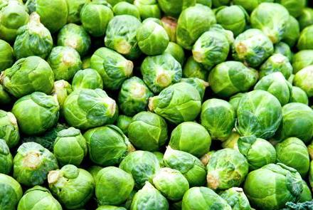 Big pile of organic Brussels sprouts at market