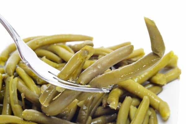 Cooked green beans on a white background