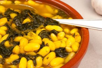 Spanish bean stew with spinach leaves