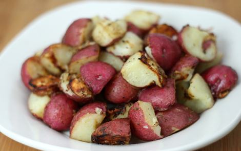Cut up red potatoes in a bowl.