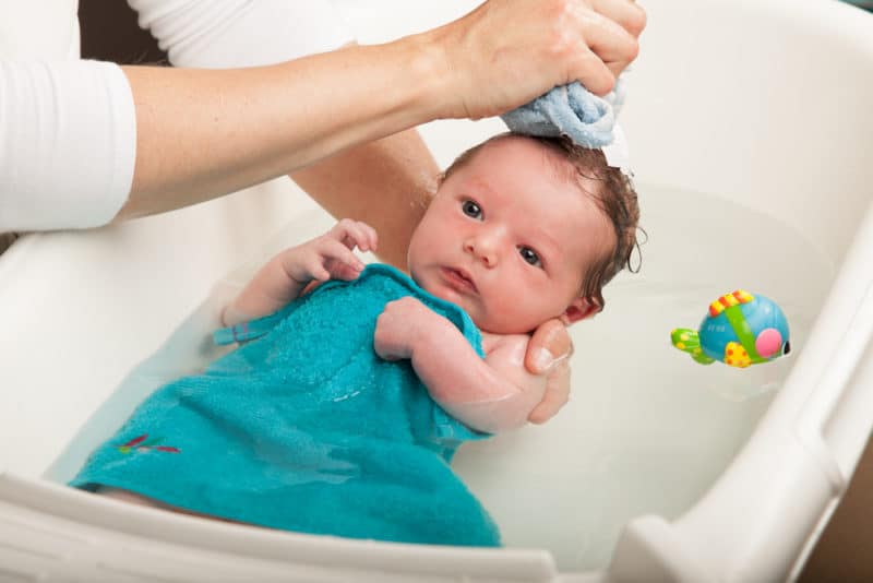 newborn baby in baby bath