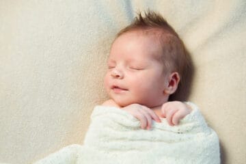 sleeping baby with funny hair