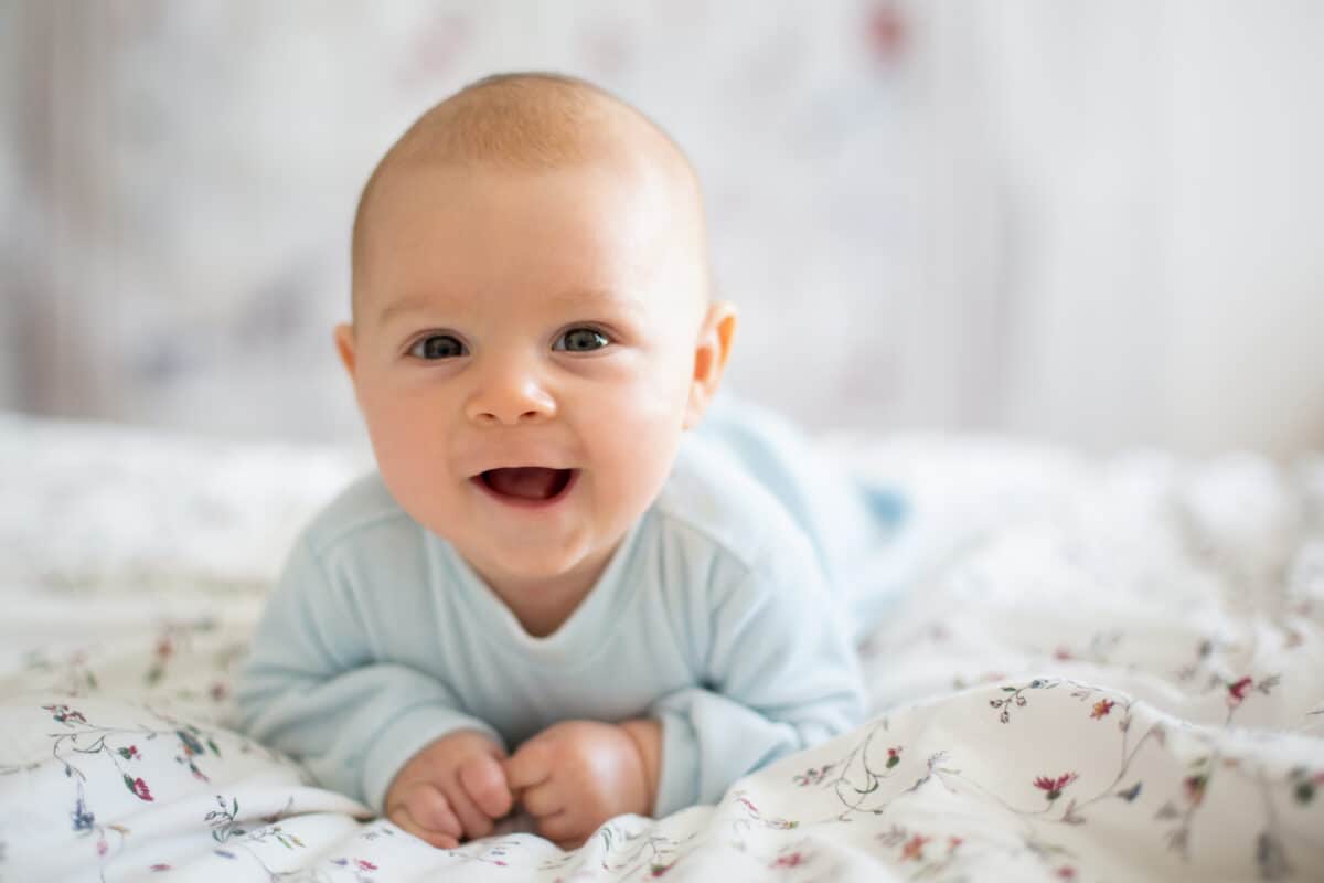 cute baby boy on his belly smiling