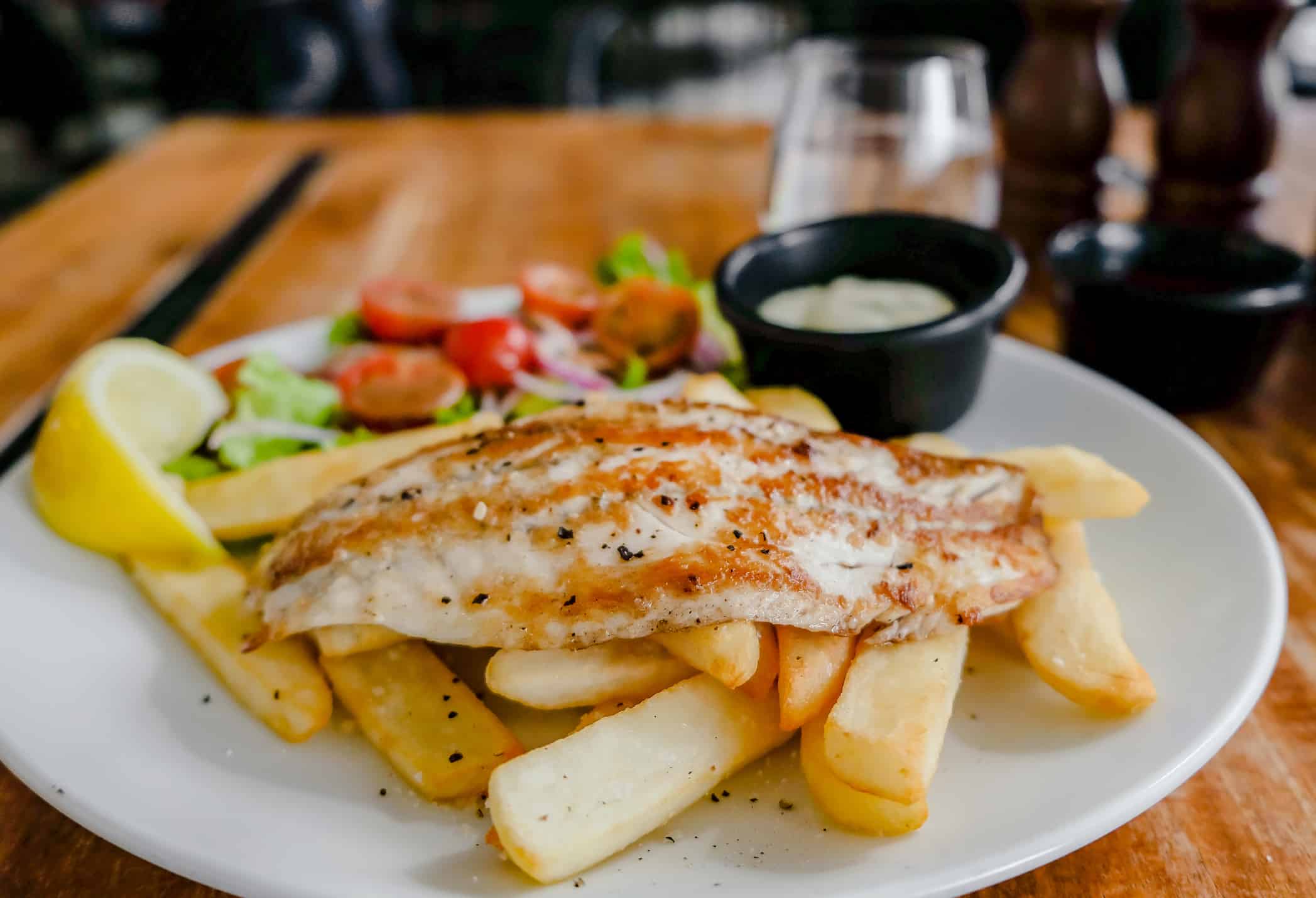 fresh fish and chips with fries, salad and tartar sauce