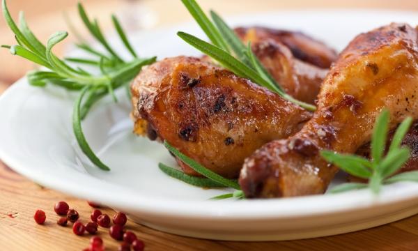 Baked chicken legs with fresh rosemary.