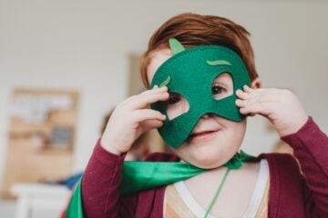 boy holding green mask
