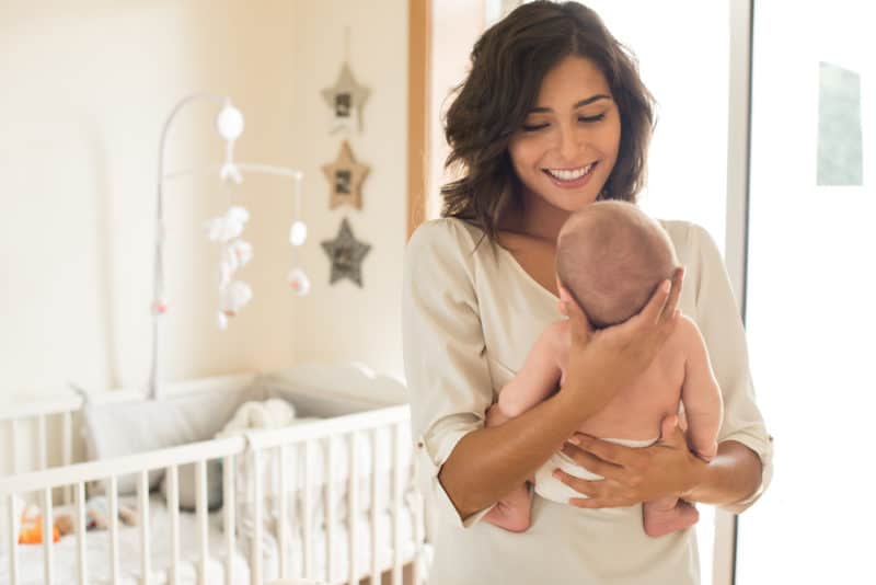 mom and newborn baby in baby nursery