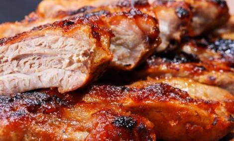 Grilled pork ribs on wooden plate