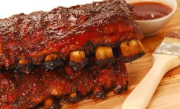 Two slabs of delicious BBQ spare ribs with dipping sauce