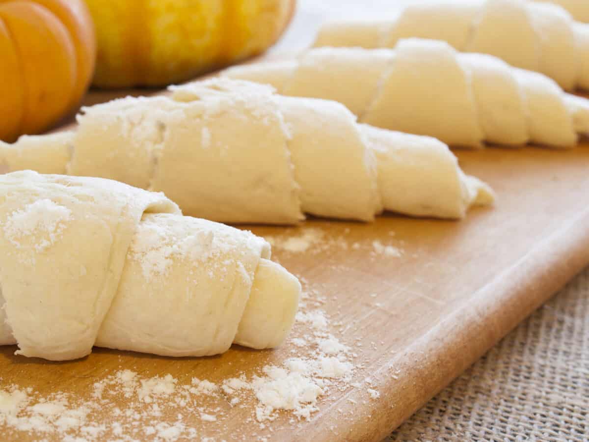 Pumpkin Crescent Rolls are easy to make - Crescent roll dough rolled up and ready to bake.