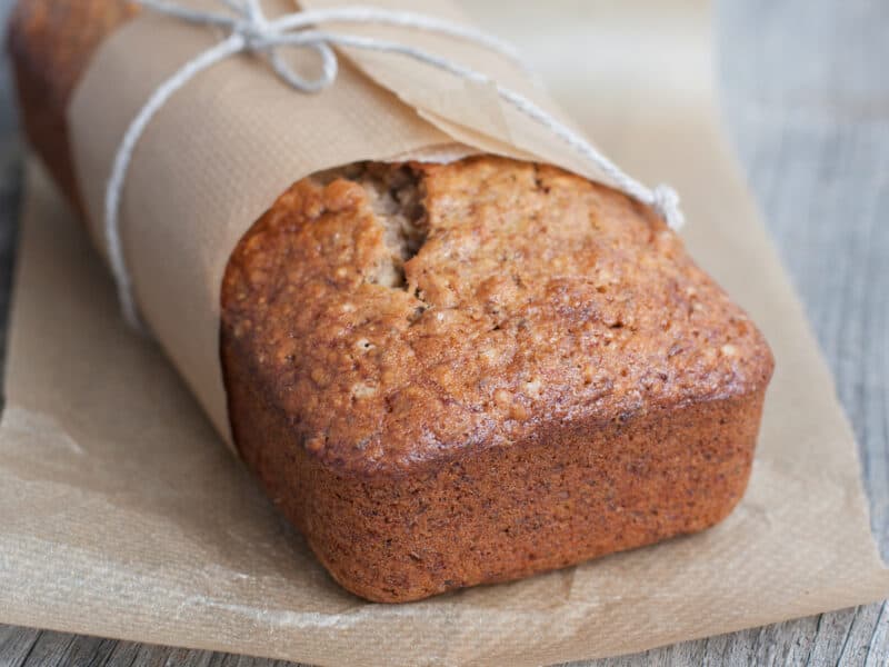 Banana Cranberry Bread wrapped in parchment paper and a string