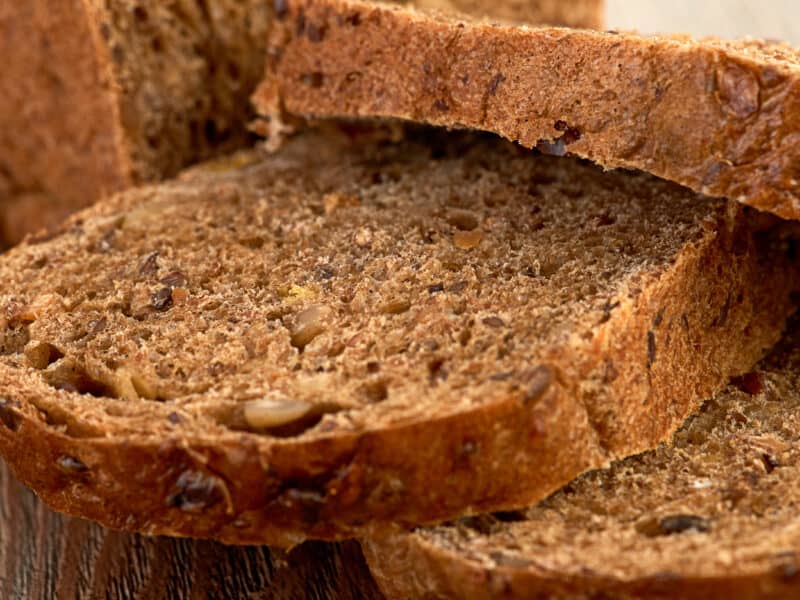 Country brown bread sliced and stacked, looking delicious