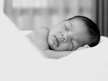 sleeping baby in a black and white picture