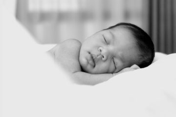 sleeping baby in a black and white picture