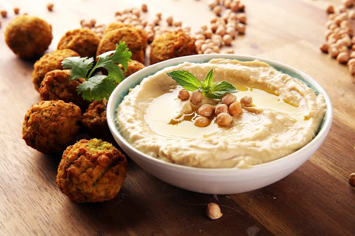 Traditional homemade hummus, falafel, and chickpea in the background. Jewish Cuisine.