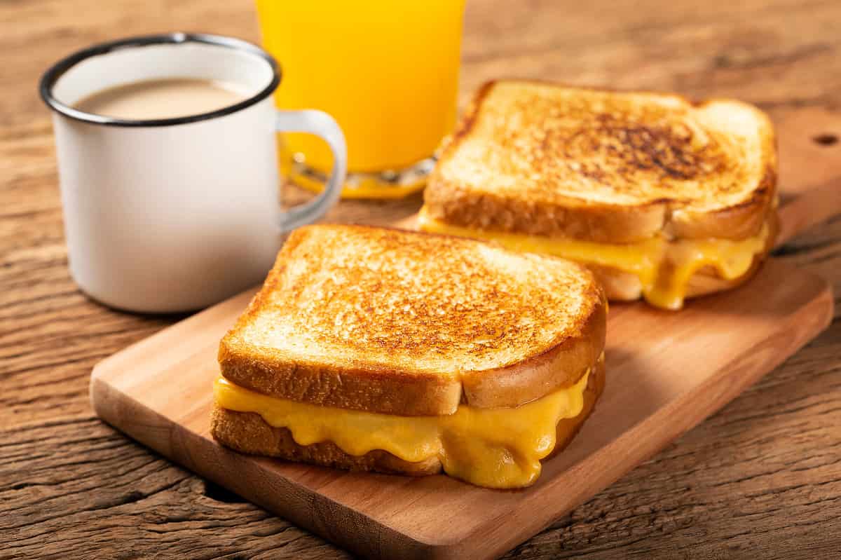 Grilled ham and cheese. Sandwich with cheese and ham on the grill.