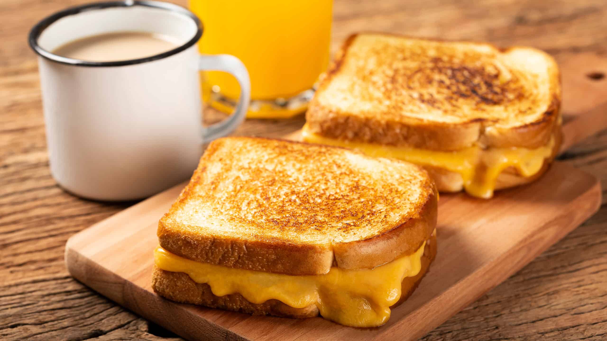 Grilled ham and cheese. Sandwich with cheese and ham on the grill.