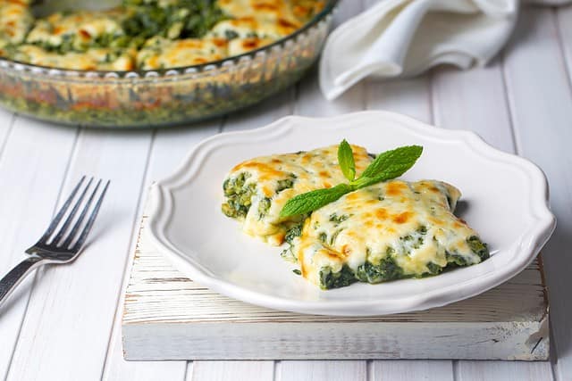 Baked Spinach with cheese is delicious Italian food cuisine. Spinach gratin.