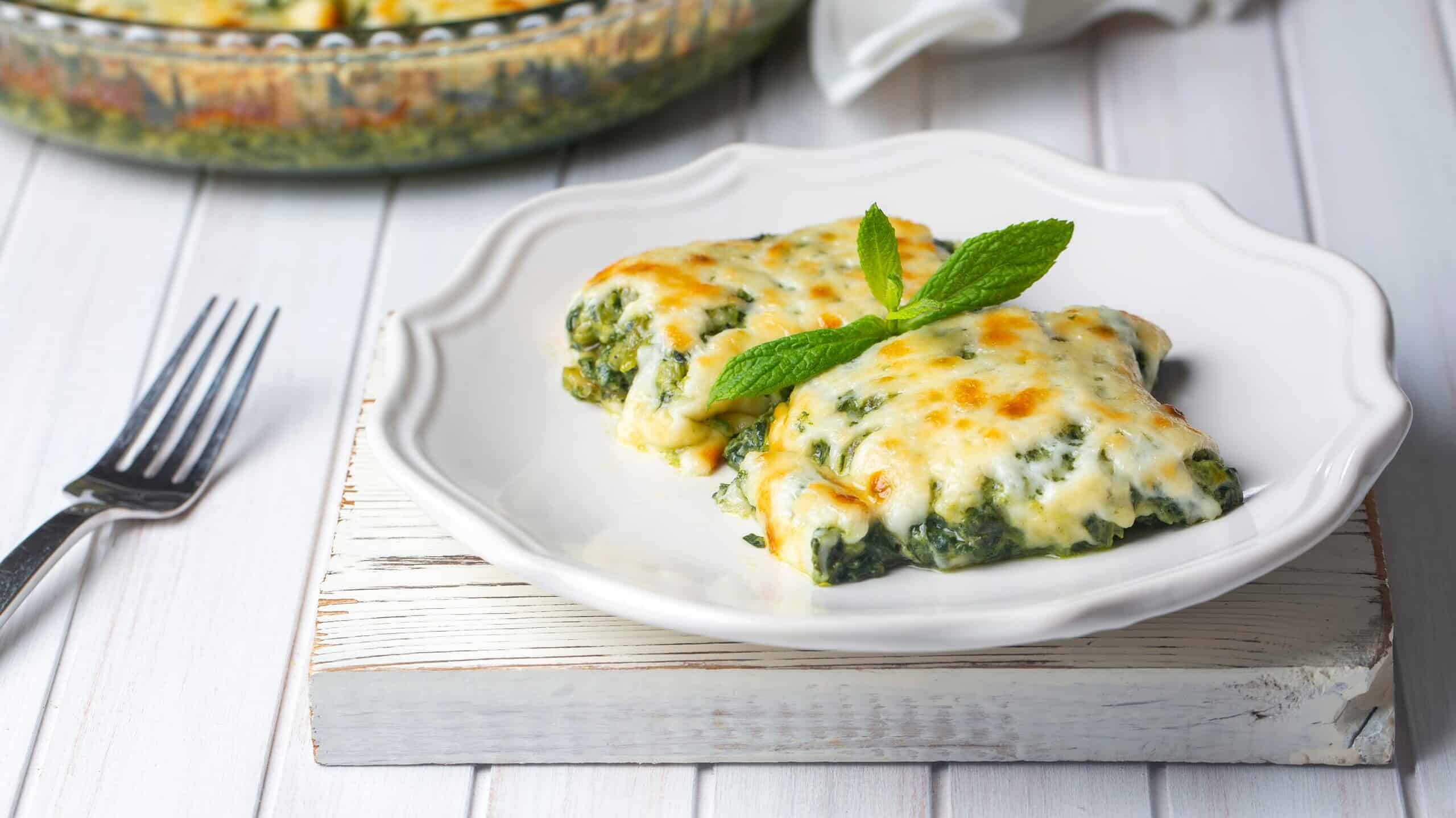 Baked Spinach with cheese is delicious Italian food cuisine. Spinach gratin.