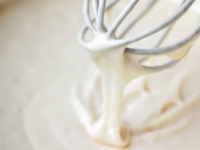 Yellow cake mix banana bread - close-up of the cake/bread batter already mixed and smooth in the bowl with whisk