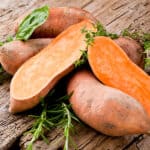 Yams and Apples - Raw yams piled on a wooden table, potato, sweet, wood, yam, orange, vegetable, raw, fresh, root, food