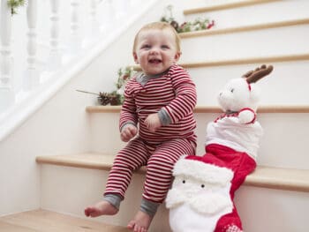 Toddler on stairs with Christmas stocking