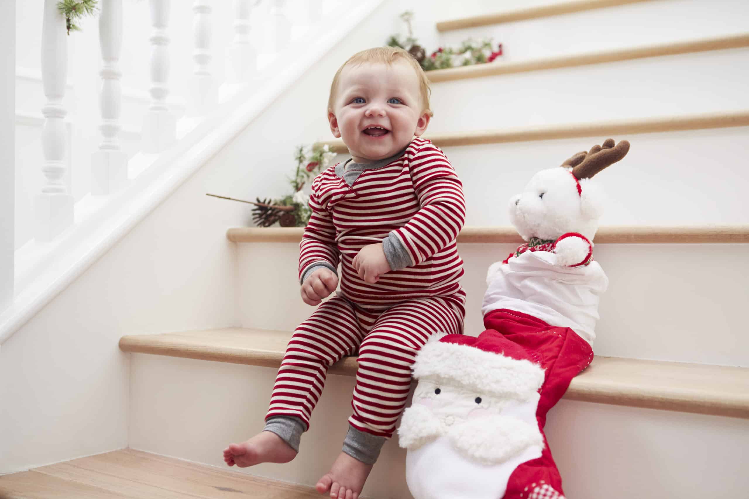 Toddler on stairs with Christmas stocking