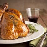 A whole Herbed Roasted Turkey on a plate ready to be served, Roast Chicken, Table, Baked, Brown, Celebration